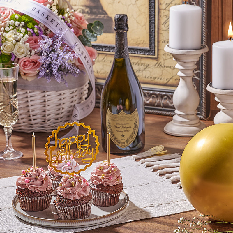 Four birthday cupcakes with wine and a flower basket