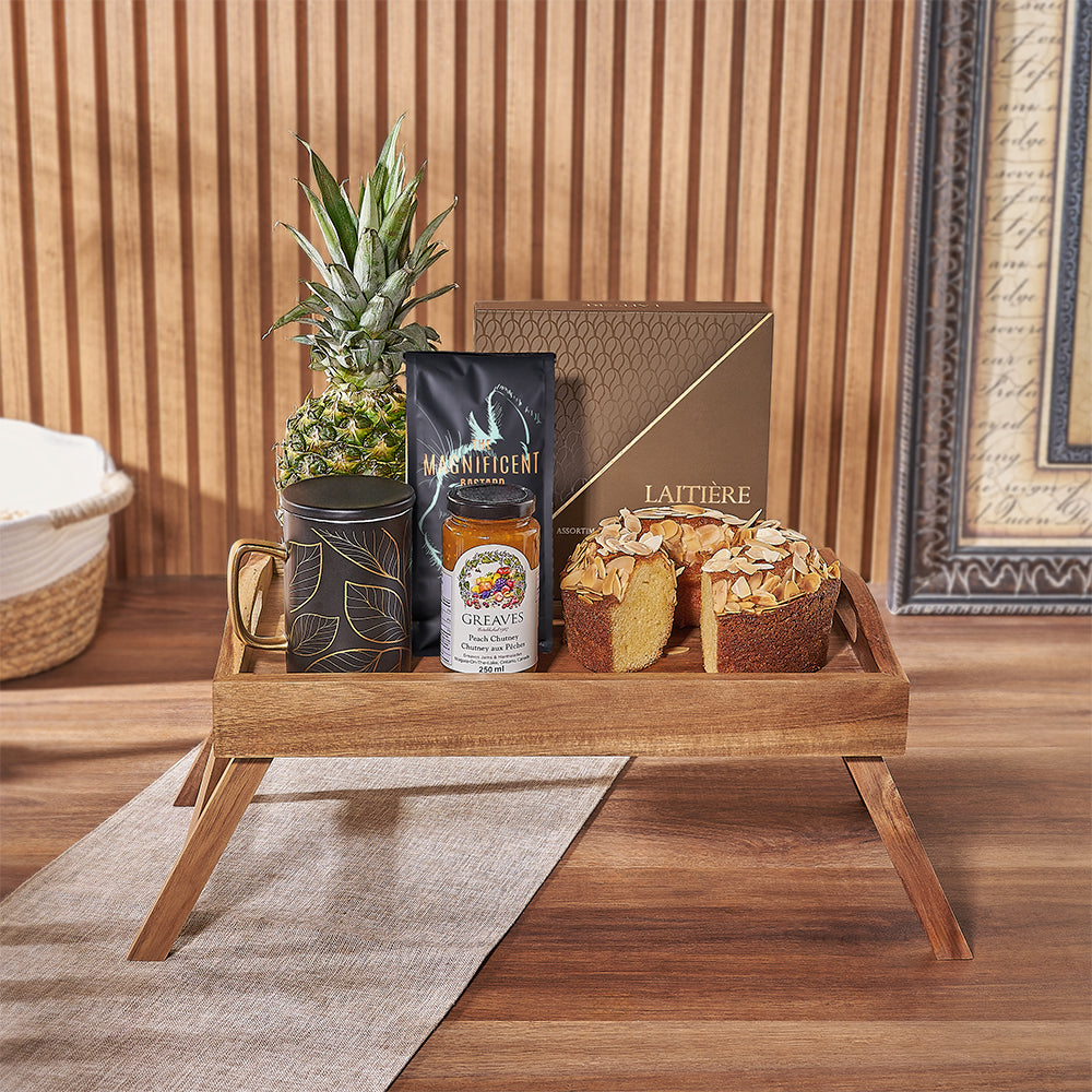 Start their day right with our Morning Decadence Gourmet Gift Set! Packed with coffee, coffee cake, coffee chocolate truffles, a fresh pineapple, peach chutney, a black &amp; gold mug, and a wooden bed tray, Toronto delivery