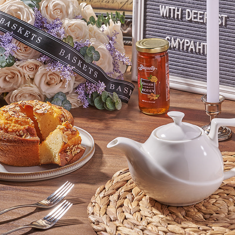 Almond bread with a tea pot and a white bouquet of flowers