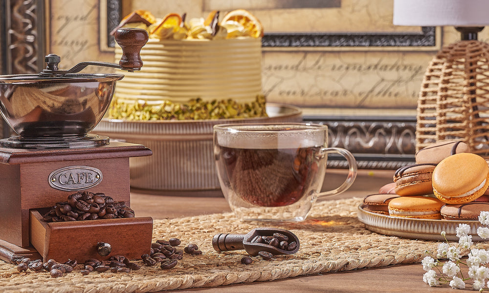 A cozy arrangement of coffee, pastries, and a grinder.