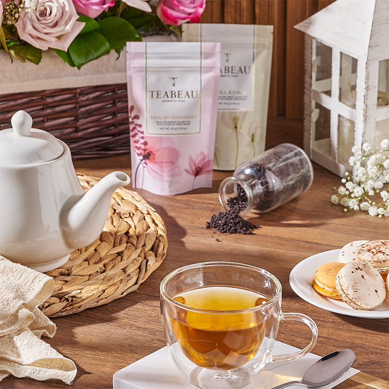 Tea cup with macaroons and flowers